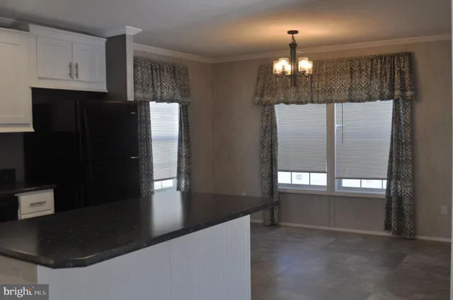 a view of an empty room with cabinet and stairs