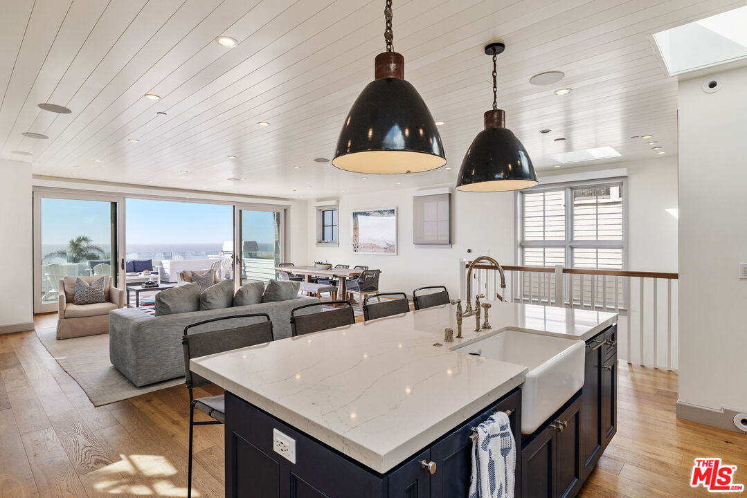 703 Bayview Drive Manhattan Beach, CA 90266 - Photo 12 of 36 a large living room with stainless steel appliances kitchen island a table and chairs