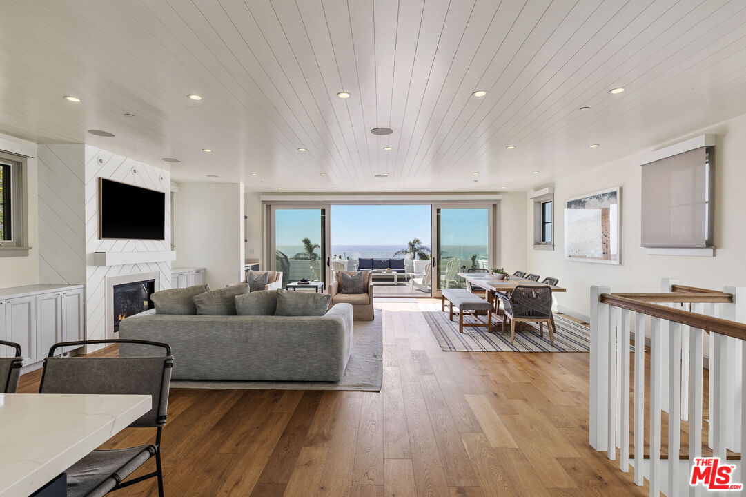 703 Bayview Drive Manhattan Beach, CA 90266 - Photo 14 of 36 a living room with furniture a flat screen tv and a fireplace