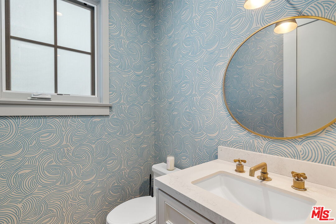 703 Bayview Drive Manhattan Beach, CA 90266 - Photo 15 of 36 a bathroom with a sink and a mirror