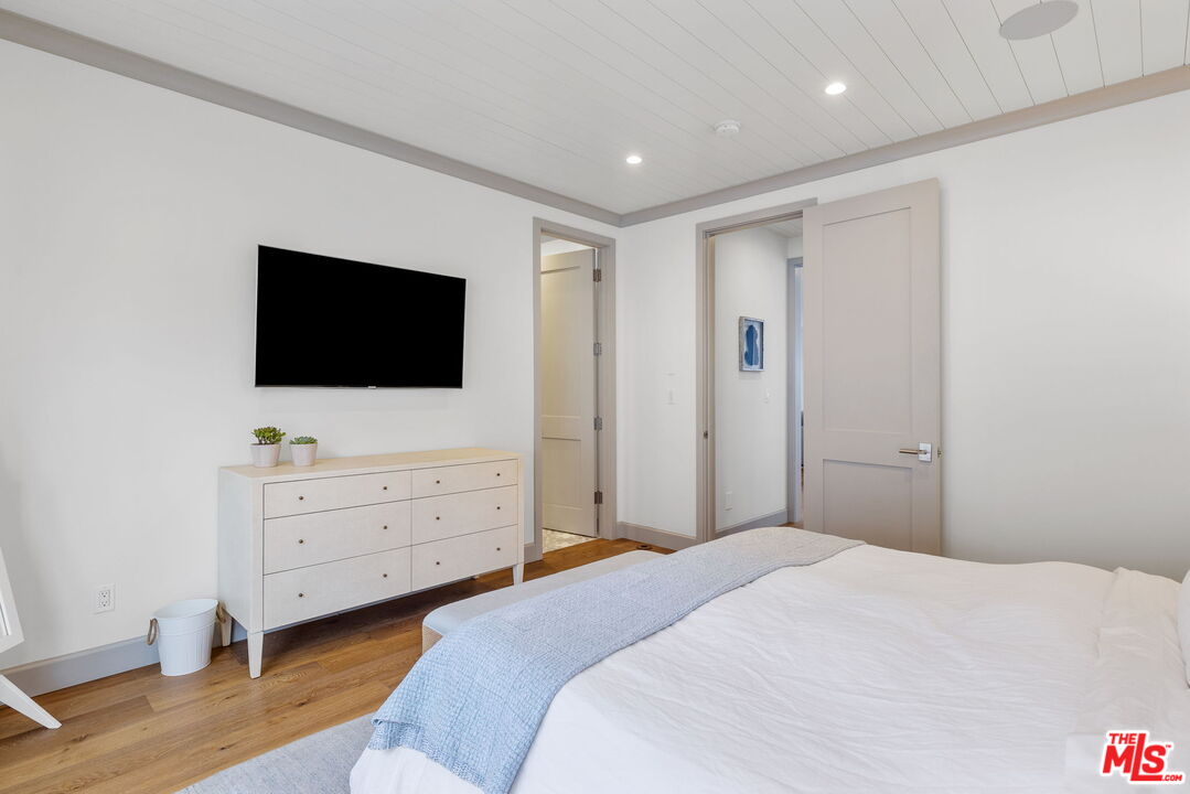 703 Bayview Drive Manhattan Beach, CA 90266 - Photo 17 of 36 a bedroom with a bed and a flat screen tv