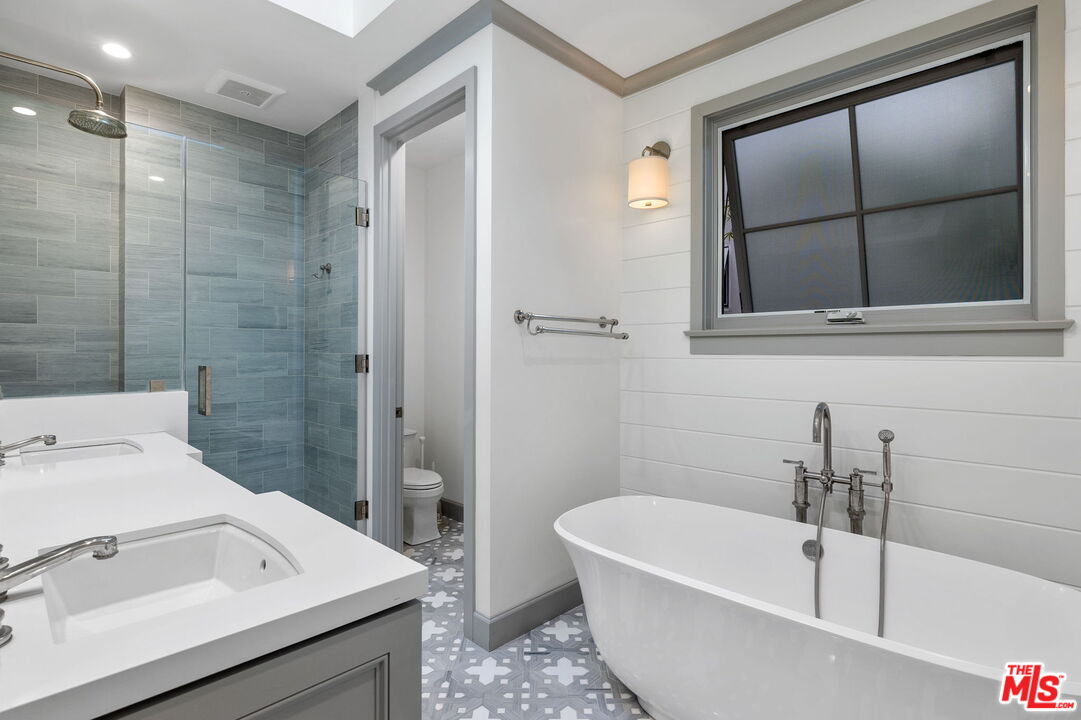 703 Bayview Drive Manhattan Beach, CA 90266 - Photo 18 of 36 a bathroom with a white tub sink and shower