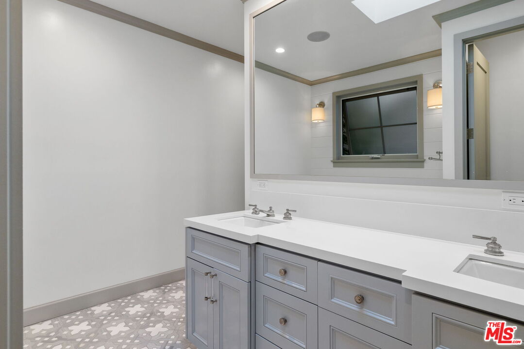 703 Bayview Drive Manhattan Beach, CA 90266 - Photo 19 of 36 a bathroom with a sink and a mirror