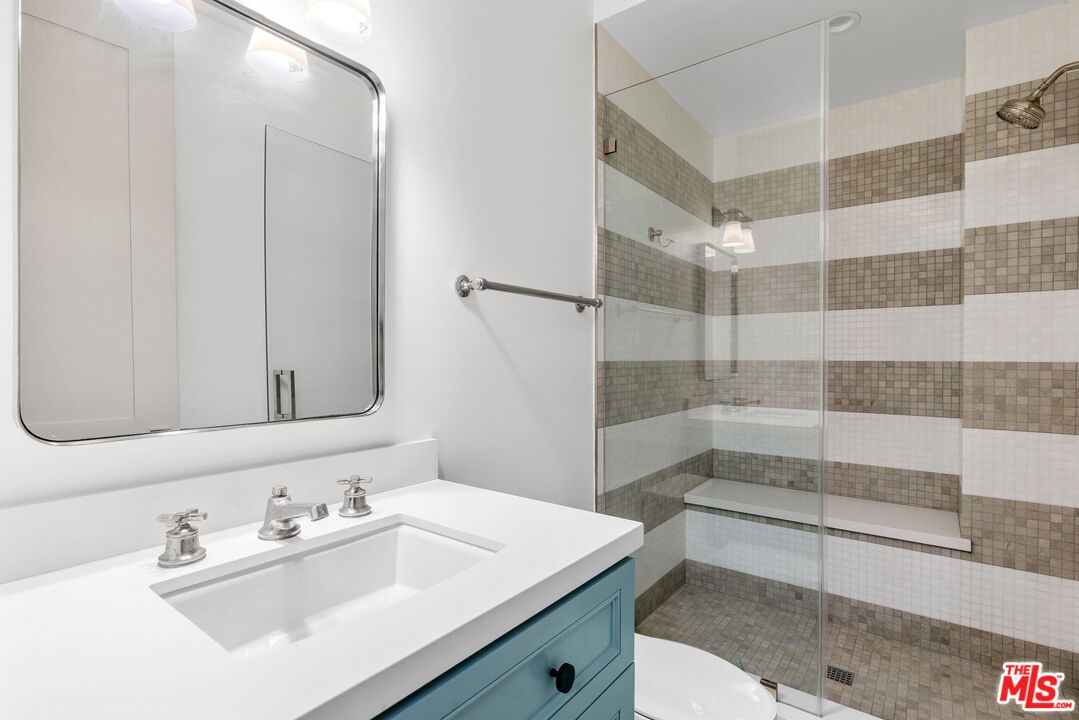 703 Bayview Drive Manhattan Beach, CA 90266 - Photo 24 of 36 a bathroom with a sink and a mirror