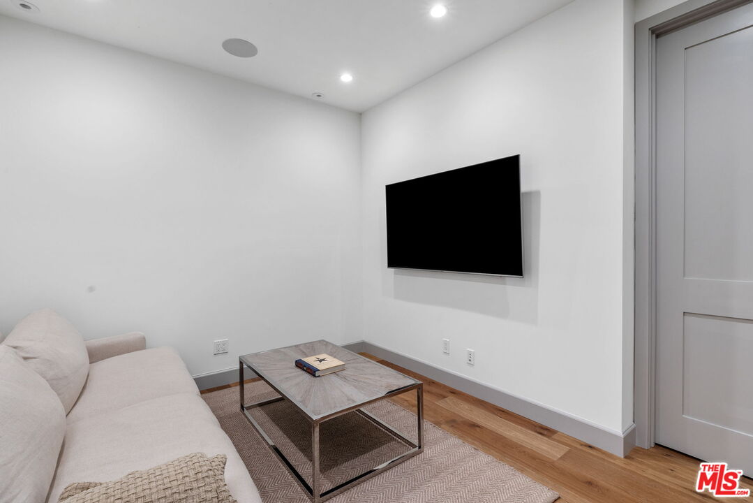 703 Bayview Drive Manhattan Beach, CA 90266 - Photo 26 of 36 a living room with furniture and a flat screen tv