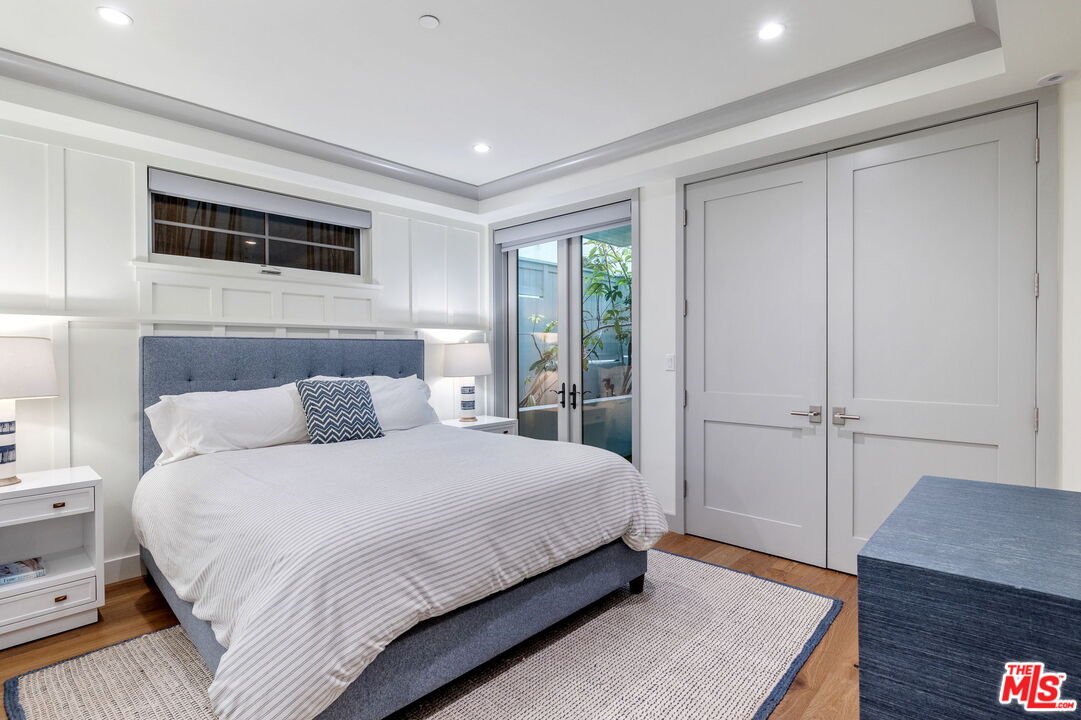 703 Bayview Drive Manhattan Beach, CA 90266 - Photo 27 of 36 a bedroom with a bed and a potted plant on the dresser