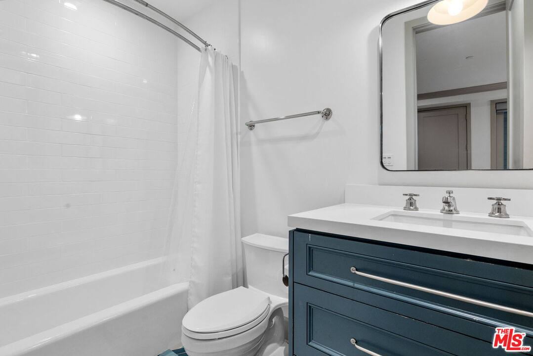 703 Bayview Drive Manhattan Beach, CA 90266 - Photo 29 of 36 a bathroom with a granite countertop sink toilet a mirror and shower