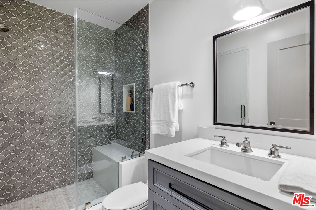 703 Bayview Drive Manhattan Beach, CA 90266 - Photo 31 of 36 a bathroom with a toilet sink and mirror