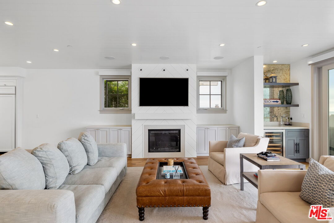 703 Bayview Drive Manhattan Beach, CA 90266 - Photo 8 of 36 a living room with furniture a fireplace and a flat screen tv