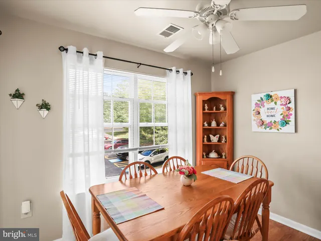 a dining room with furniture a chandelier and window