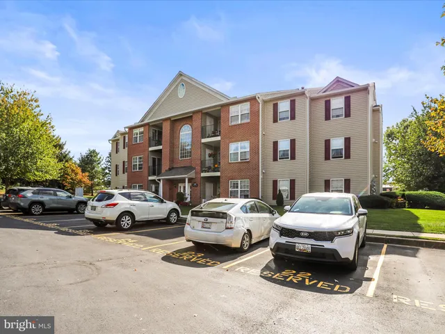 a couple of cars parked in front of a house