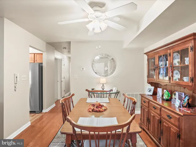 a dining room with furniture a front door and a chandelier