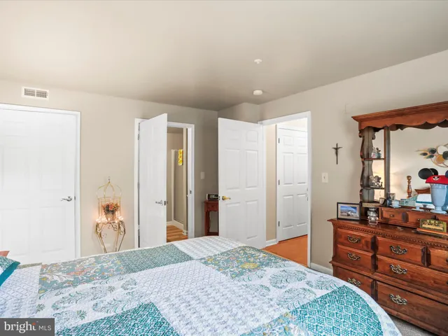 a bedroom with a bed and a dresser in it