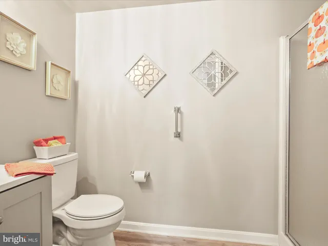 a white toilet sitting next to a bathroom sink