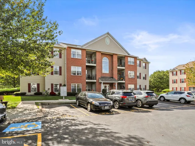 a car parked in front of a white building