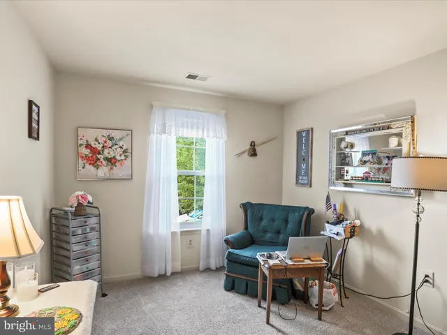 a living room with furniture a window and a flat screen tv