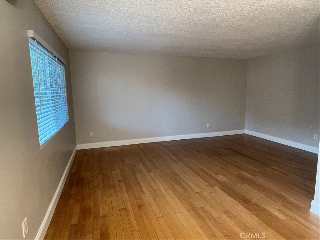 17226 Virginia Avenue, Unit D Bellflower, CA 90706 - Photo 3 of 8 a view of wooden floor in an empty room