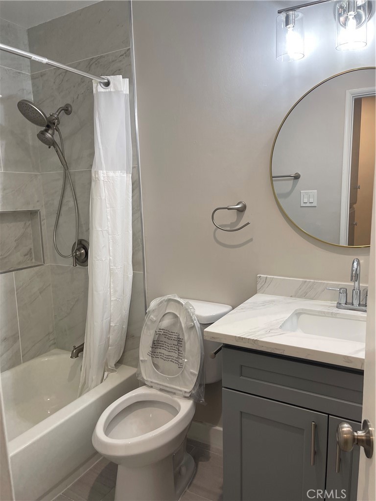 17226 Virginia Avenue, Unit D Bellflower, CA 90706 - Photo 5 of 8 a bathroom with a sink toilet and shower