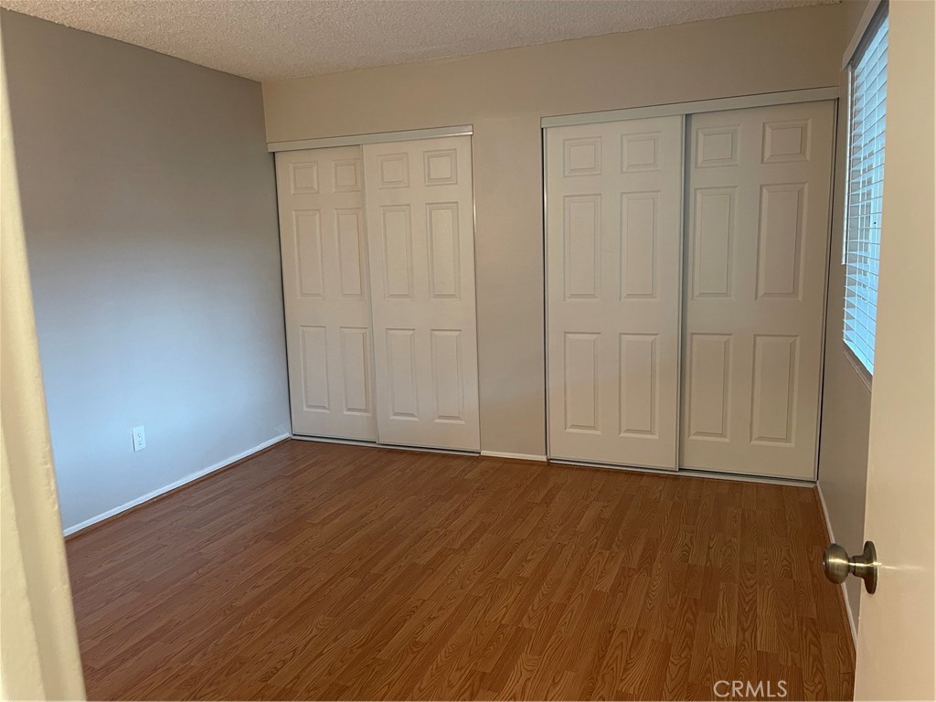 17226 Virginia Avenue, Unit D Bellflower, CA 90706 - Photo 6 of 8 a view of an empty room with wooden floor