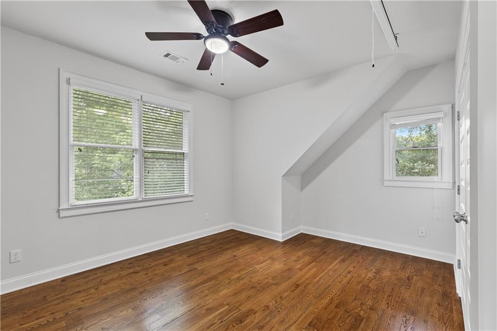 211 West Hill Street Decatur, GA 30030 - Photo 29 of 43 a view of an empty room with wooden floor and a window