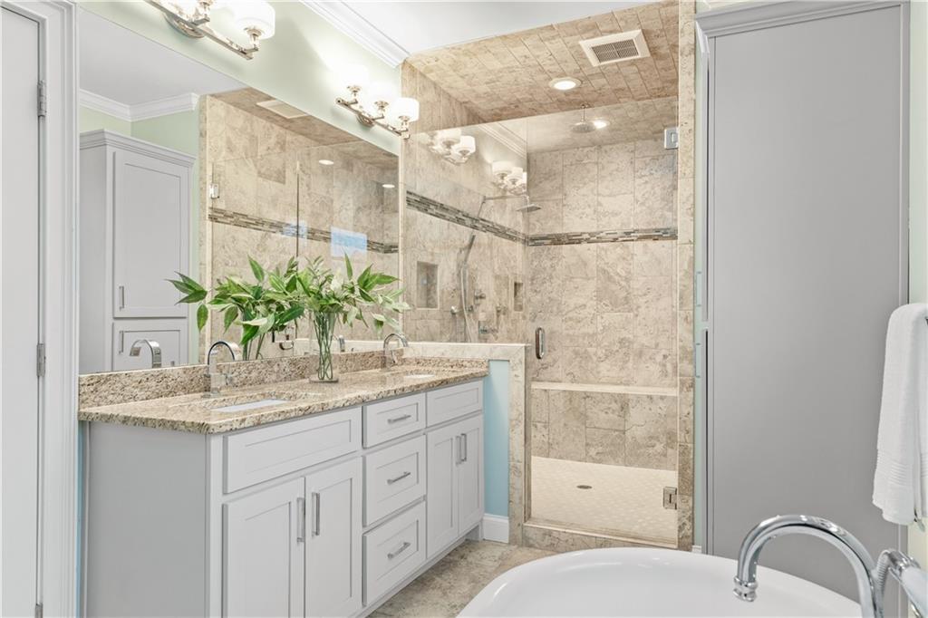 211 West Hill Street Decatur, GA 30030 - Photo 35 of 43 a bathroom with a granite countertop sink a mirror and a shower