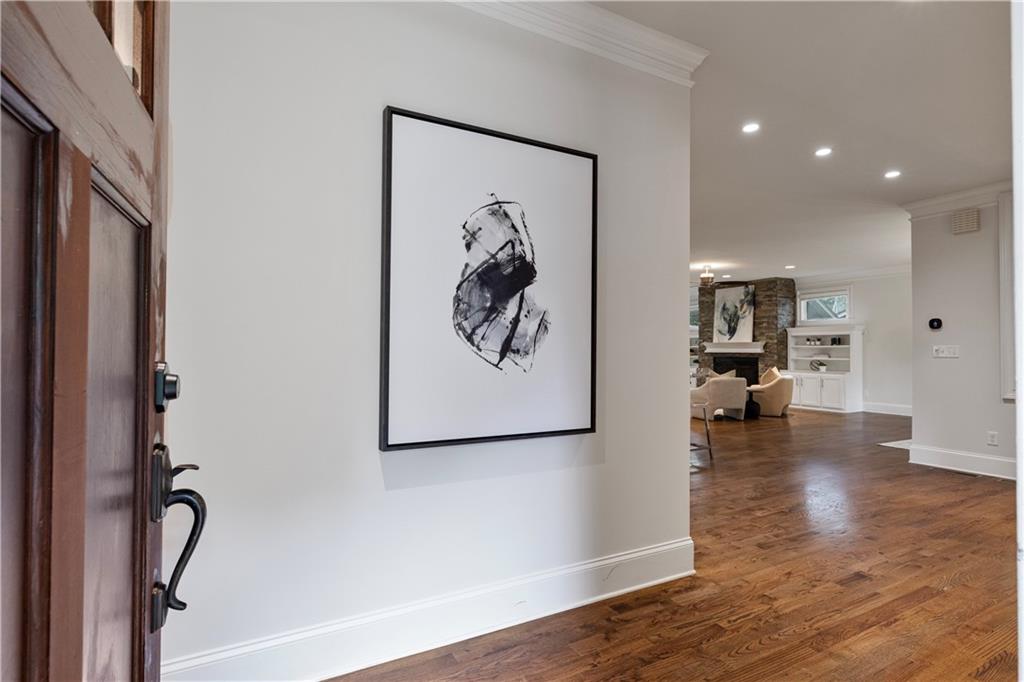 211 West Hill Street Decatur, GA 30030 - Photo 6 of 43 a view of a hallway with wooden floor and a chandelier