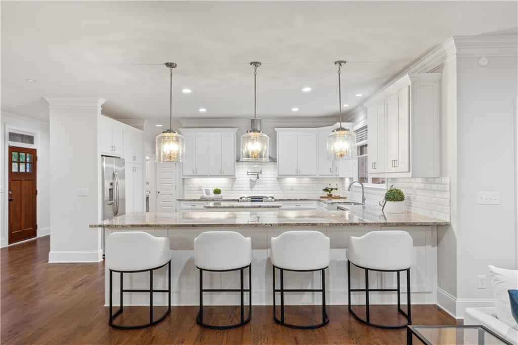 211 West Hill Street Decatur, GA 30030 - Photo 8 of 43 a kitchen with lots of counter space and chairs