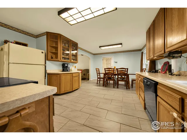a view of kitchen with furniture and a refrigerator