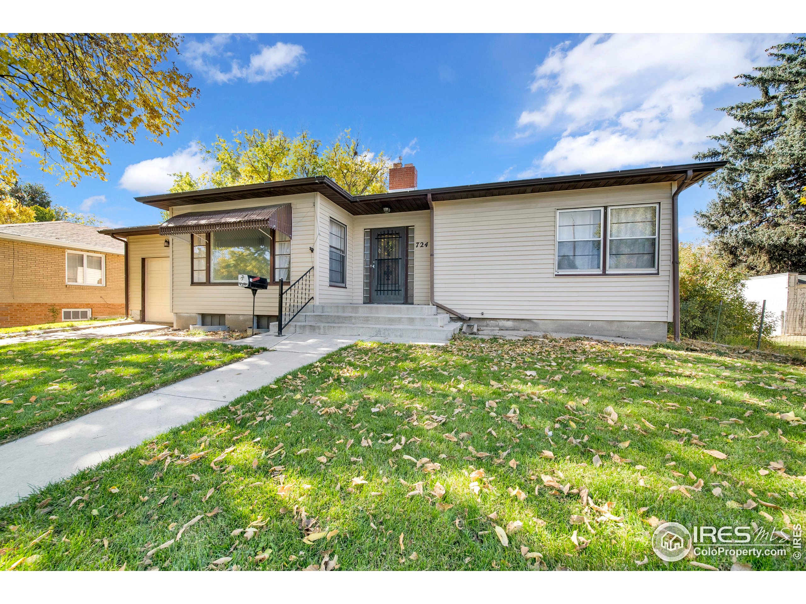 724 Carson Street Brush, CO 80723 - Photo 2 of 29 a front view of a house with garden