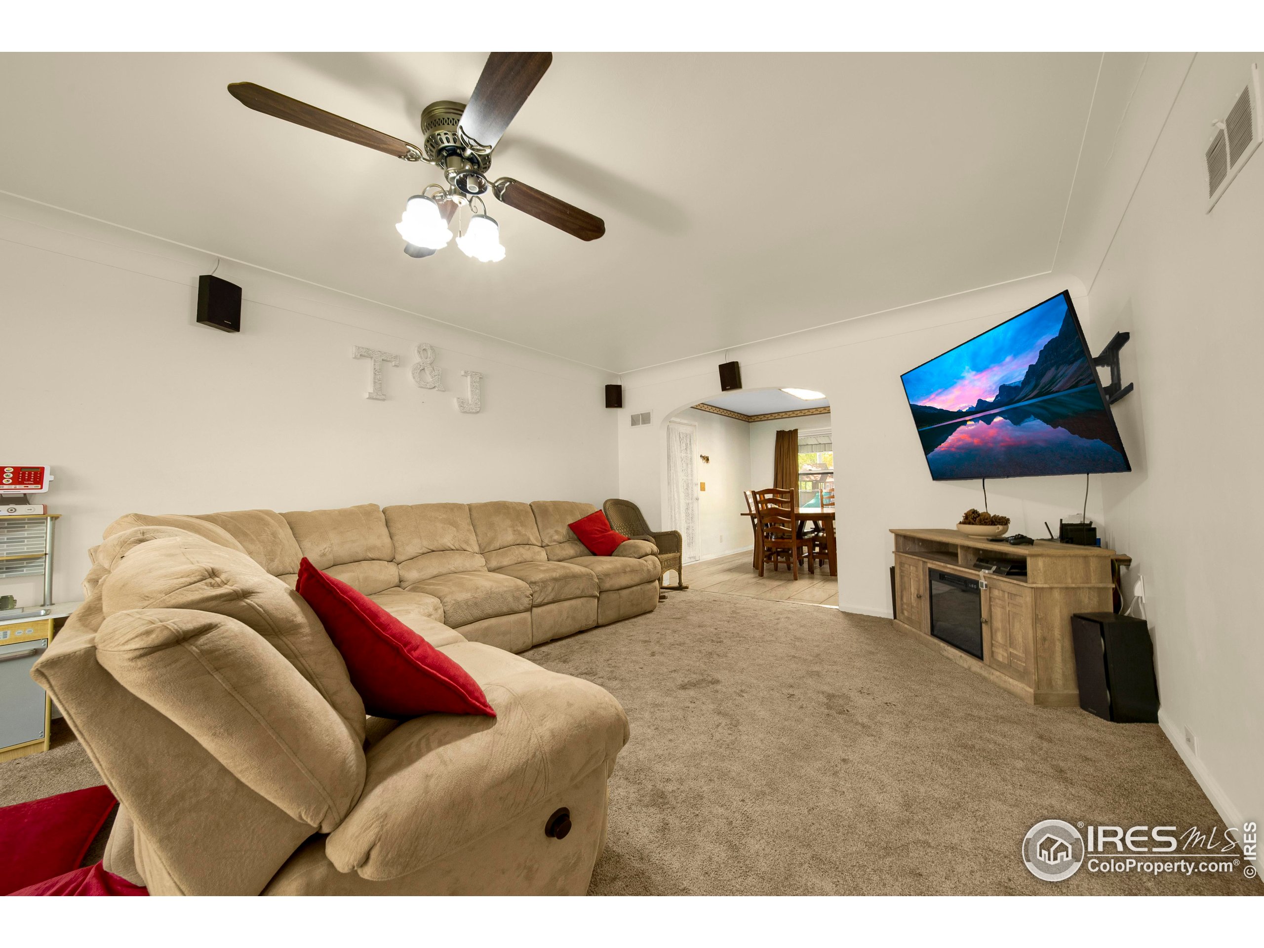 724 Carson Street Brush, CO 80723 - Photo 6 of 29 a living room with furniture and a flat screen tv