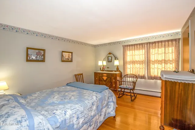 a bedroom with furniture and a large window