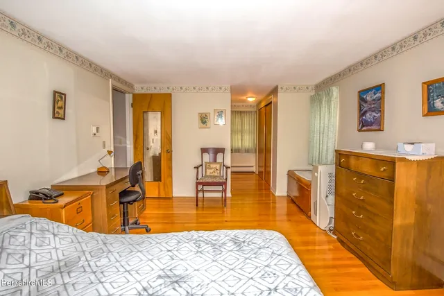 a large bedroom with a large bed and furniture