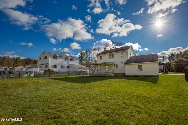 a swimming pool is sitting in the middle of a big yard