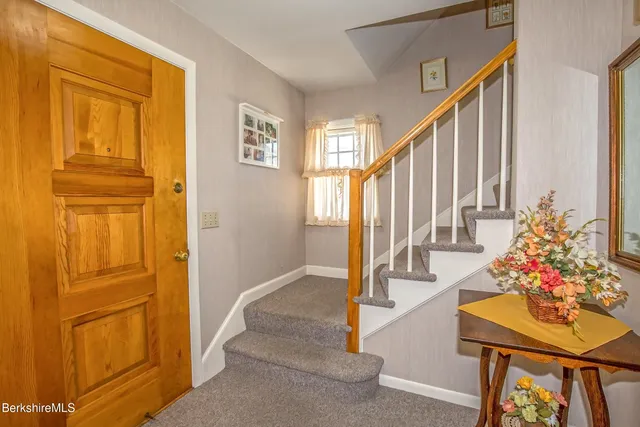 a view of an entryway with wooden floor and door