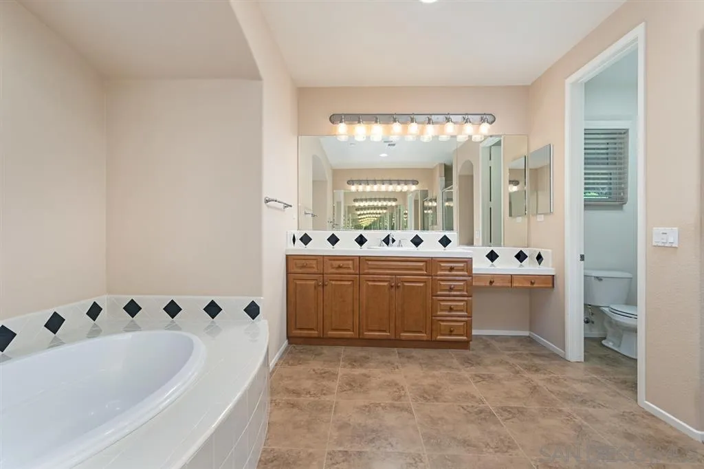 1757 Monte Mar Road Vista, CA 92084 - Photo 17 of 25 a bathroom with a tub sink and mirror