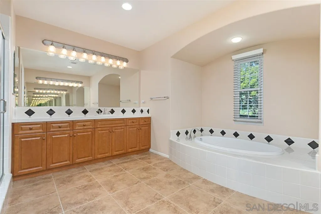 1757 Monte Mar Road Vista, CA 92084 - Photo 18 of 25 a bathroom with a tub sink and mirror