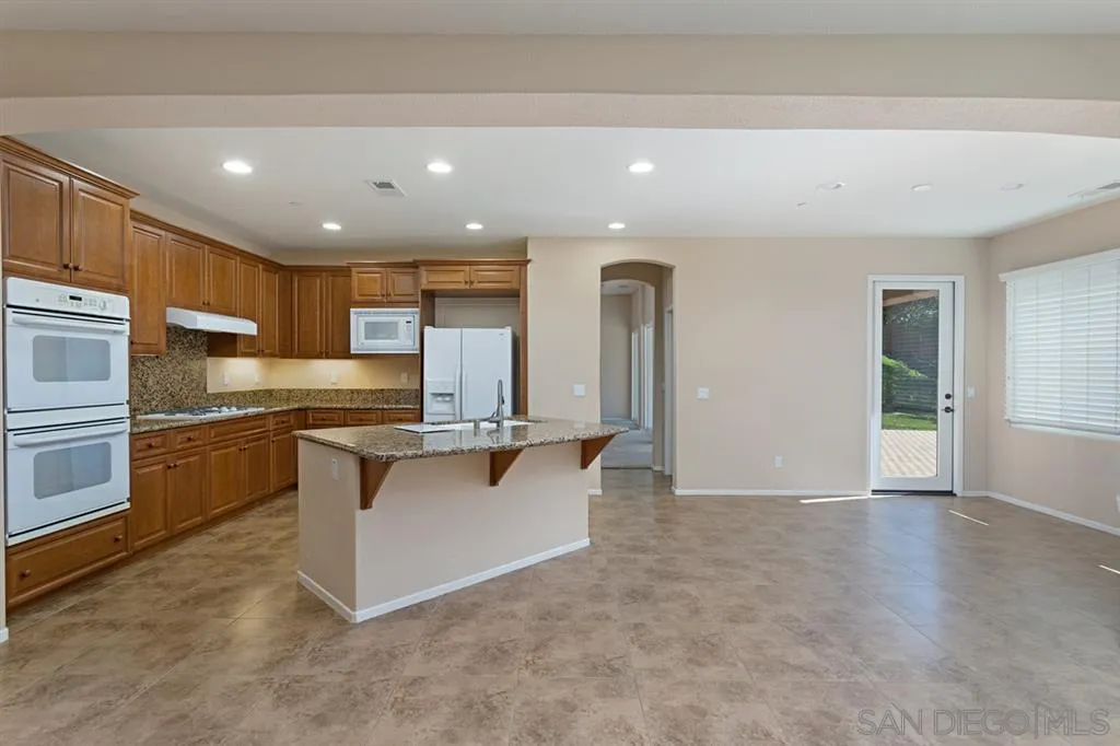 1757 Monte Mar Road Vista, CA 92084 - Photo 2 of 25 a large kitchen with stainless steel appliances a large counter top