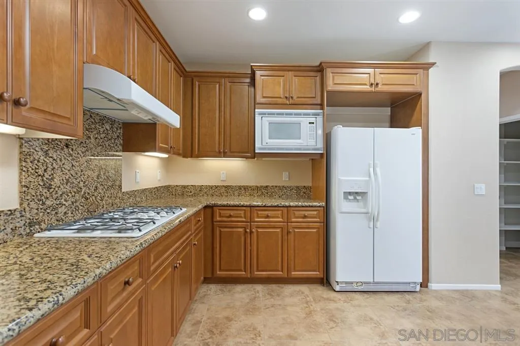 1757 Monte Mar Road Vista, CA 92084 - Photo 3 of 25 a kitchen with stainless steel appliances granite countertop a refrigerator and a stove top oven