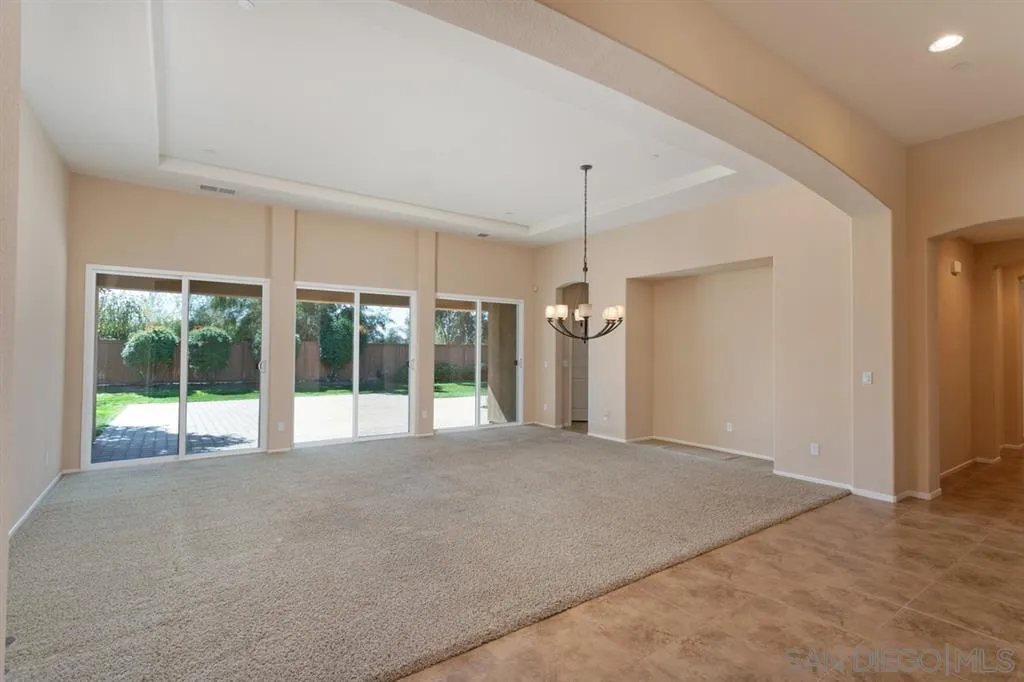 1757 Monte Mar Road Vista, CA 92084 - Photo 8 of 25 a view of an empty room with a window and chandelier