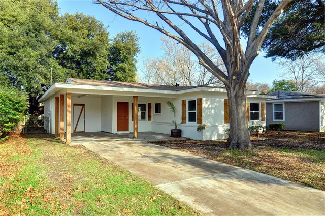 a front view of a house with a yard in front of it