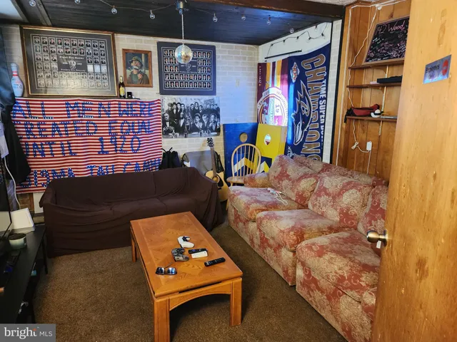 a living room with furniture and wall paintings