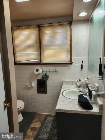 a bathroom with a sink a toilet and mirror