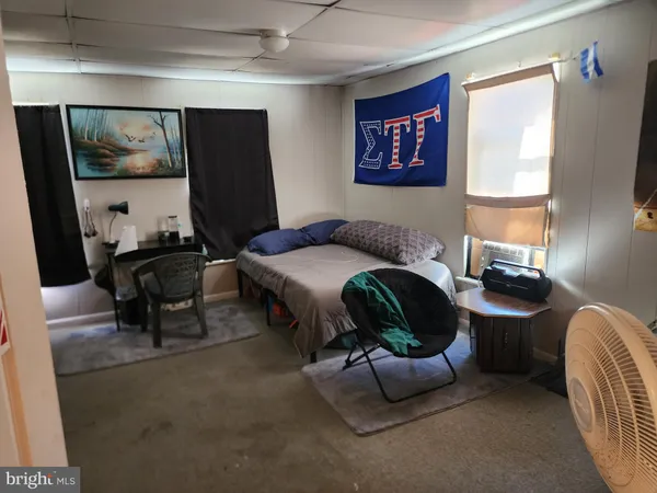 a bedroom with a bed and a mirror