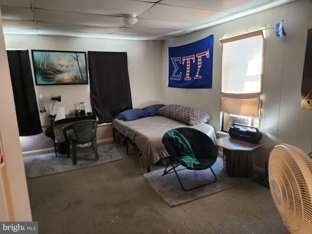 a bedroom with a bed and a mirror