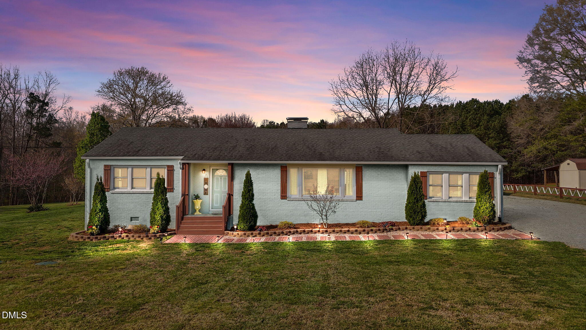 a front view of a house with yard and green space