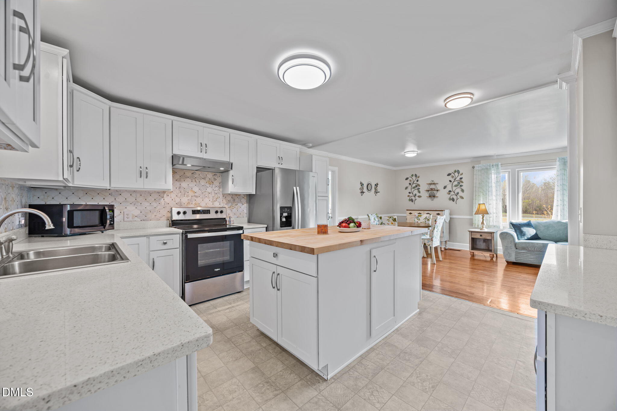 10612 Durham Road Timberlake, NC 27583 - Photo 12 of 42 a kitchen with white cabinets and stainless steel appliances