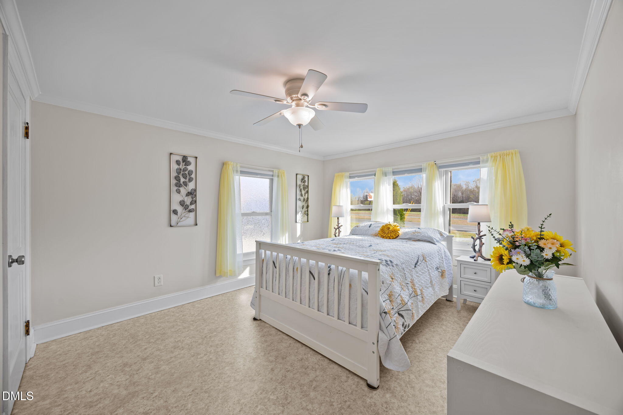 10612 Durham Road Timberlake, NC 27583 - Photo 15 of 42 a spacious bedroom with a bed and a chandelier