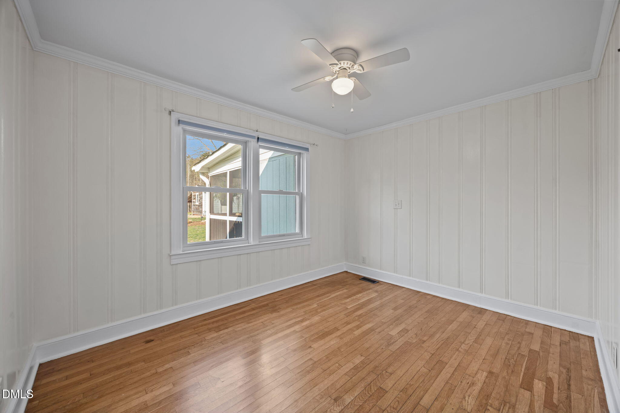 10612 Durham Road Timberlake, NC 27583 - Photo 19 of 42 a view of an empty room with wooden floor and a window