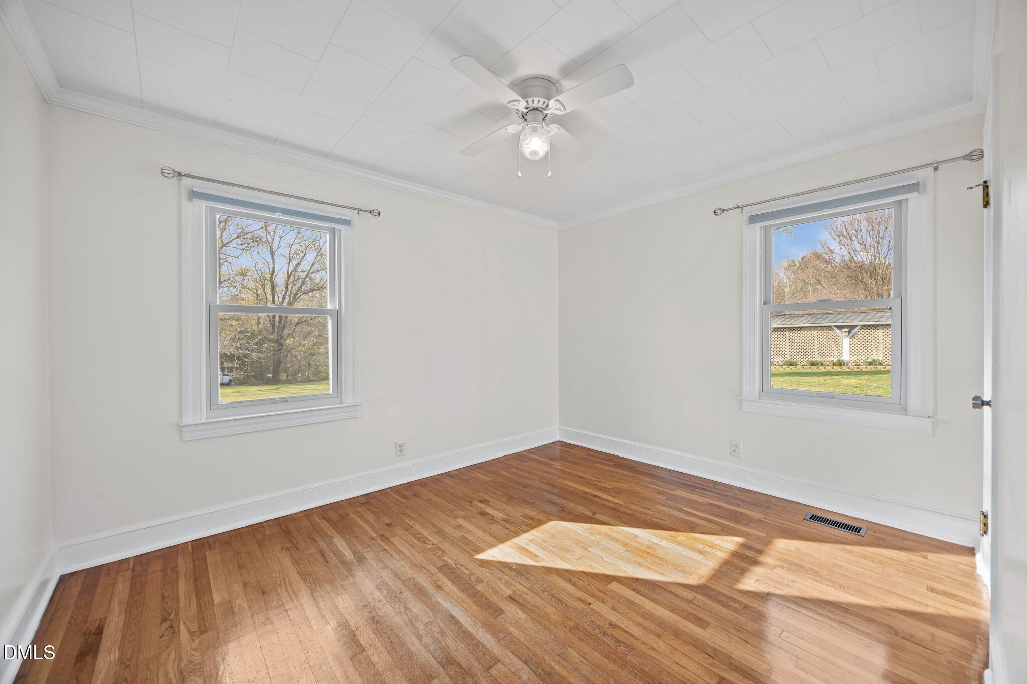 10612 Durham Road Timberlake, NC 27583 - Photo 20 of 42 a view of an empty room with window and wooden floor