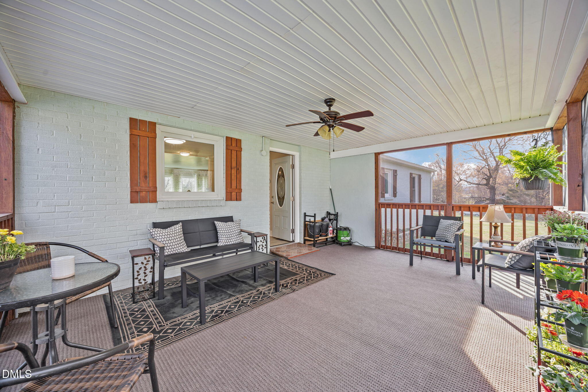 10612 Durham Road Timberlake, NC 27583 - Photo 24 of 42 a living room with furniture a fireplace and a floor to ceiling window